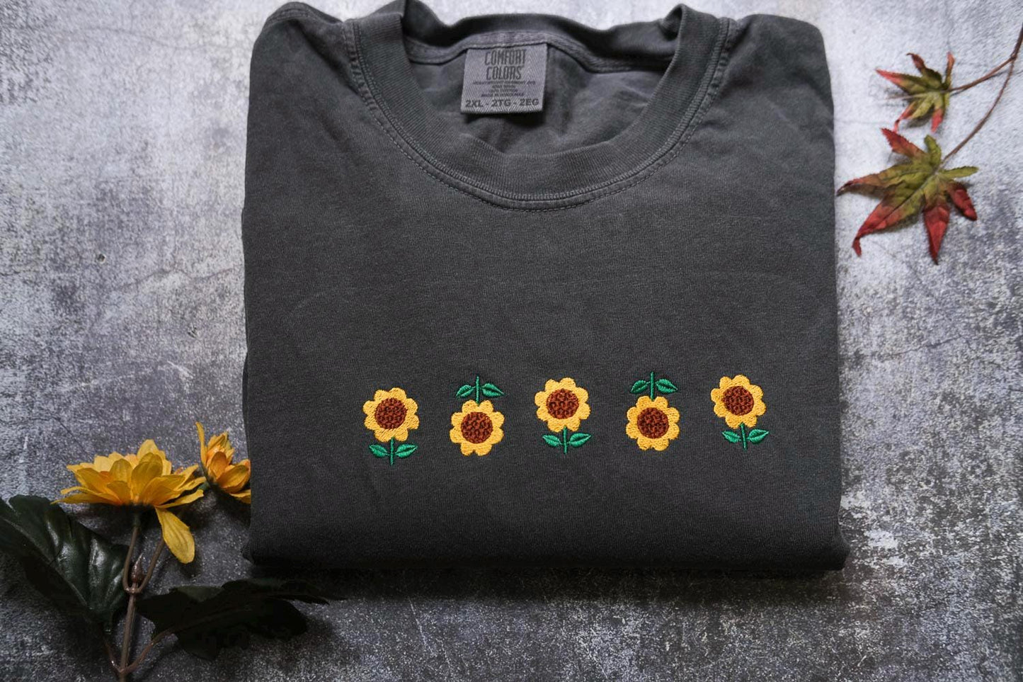 a t - shirt with embroidered sunflowers on it