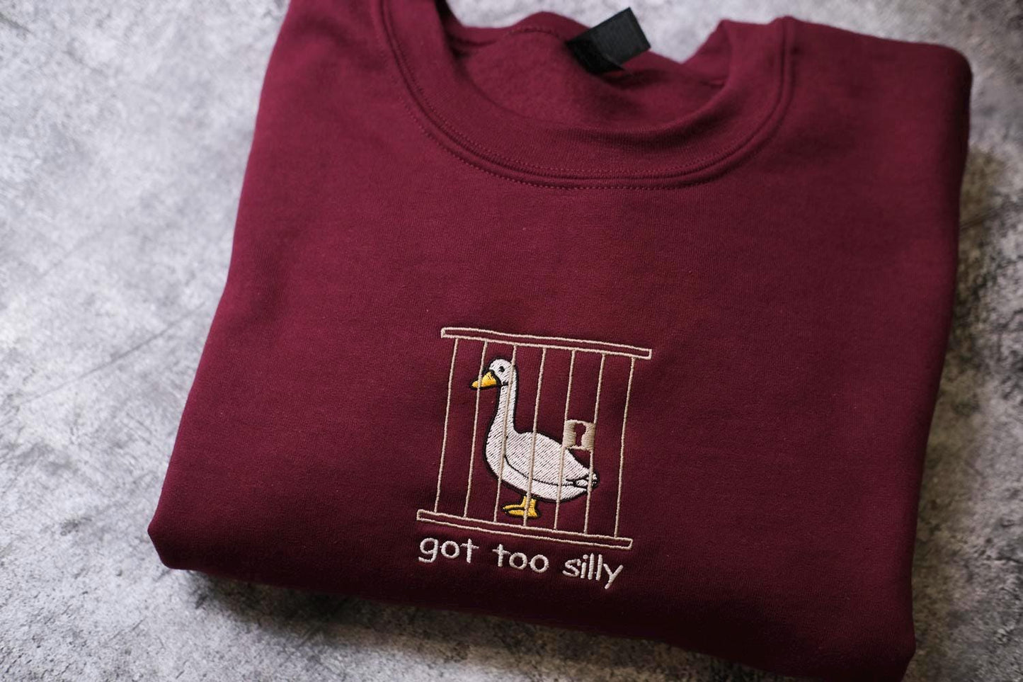 a t - shirt with a picture of a goose in a cage