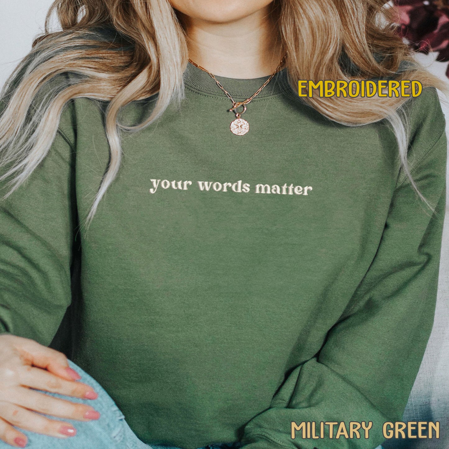 A person wearing a green sweatshirt with the text "your words matter" printed on it.