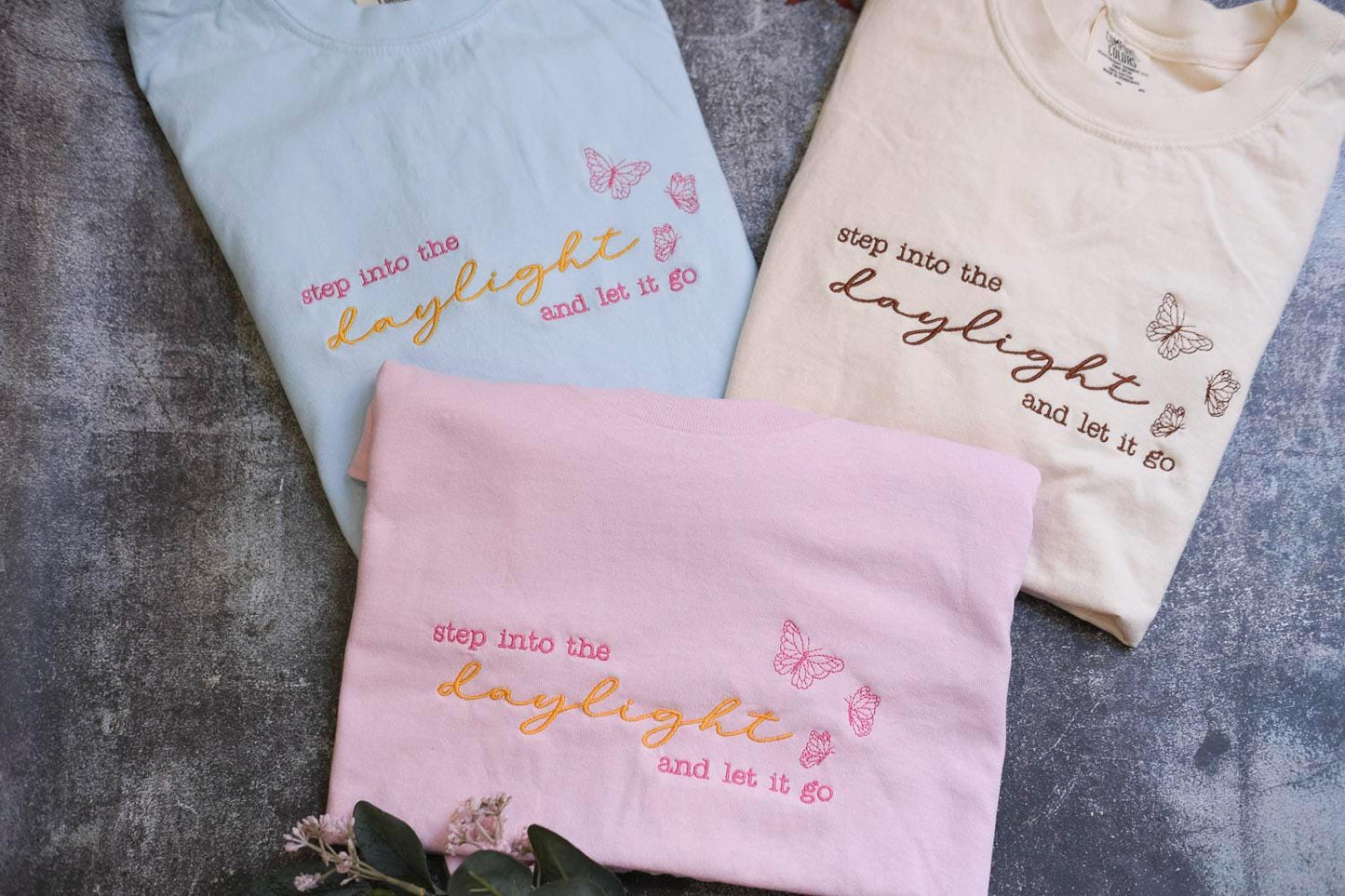three t - shirts with words and butterflies on them