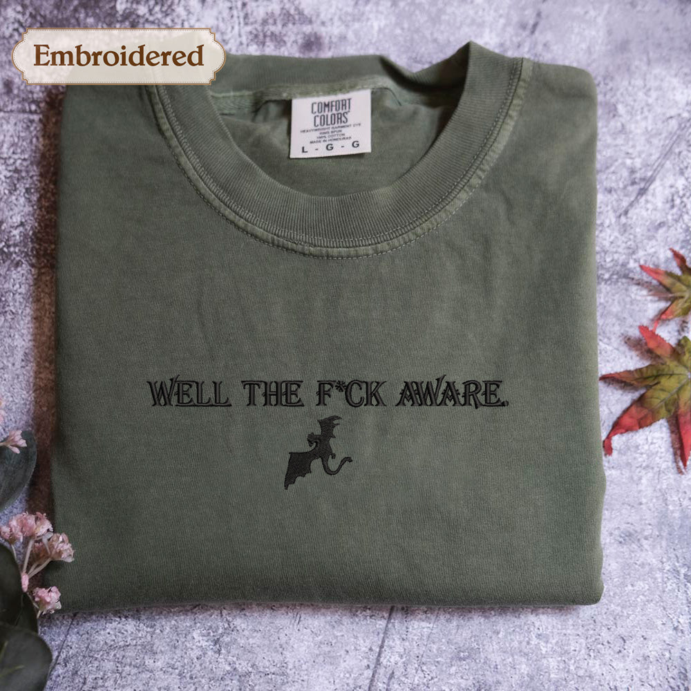 a green t-shirt with the text "WELL THE F*CK AWARE" printed on it.