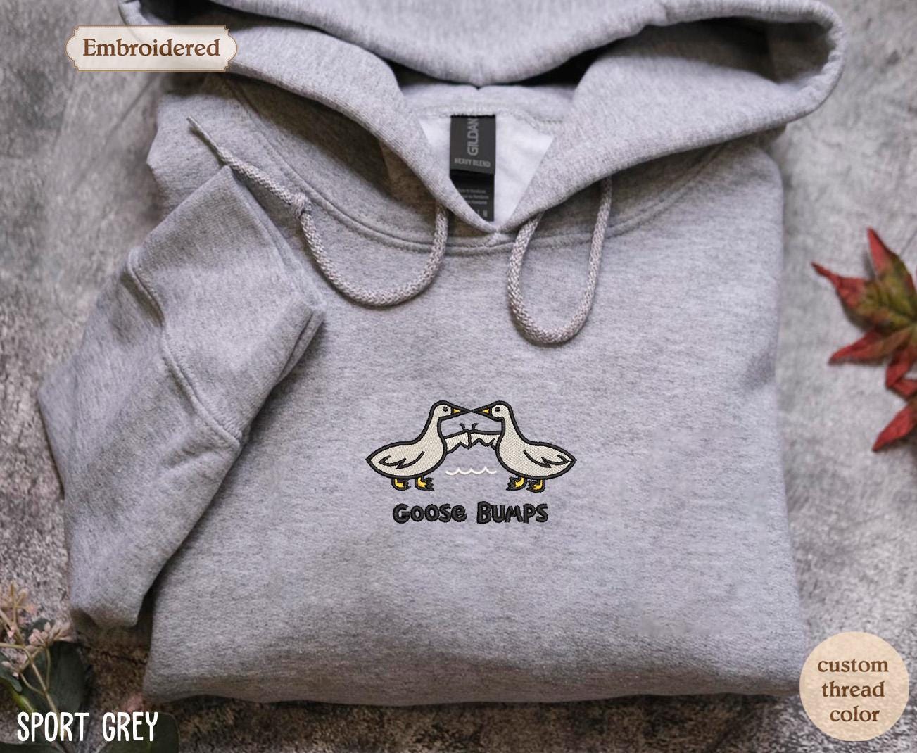 a grey hoodie with two birds on it