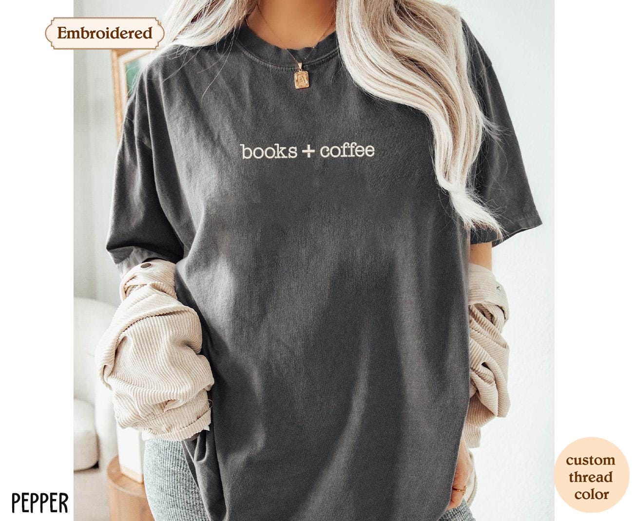 a woman wearing a t - shirt that says books + coffee