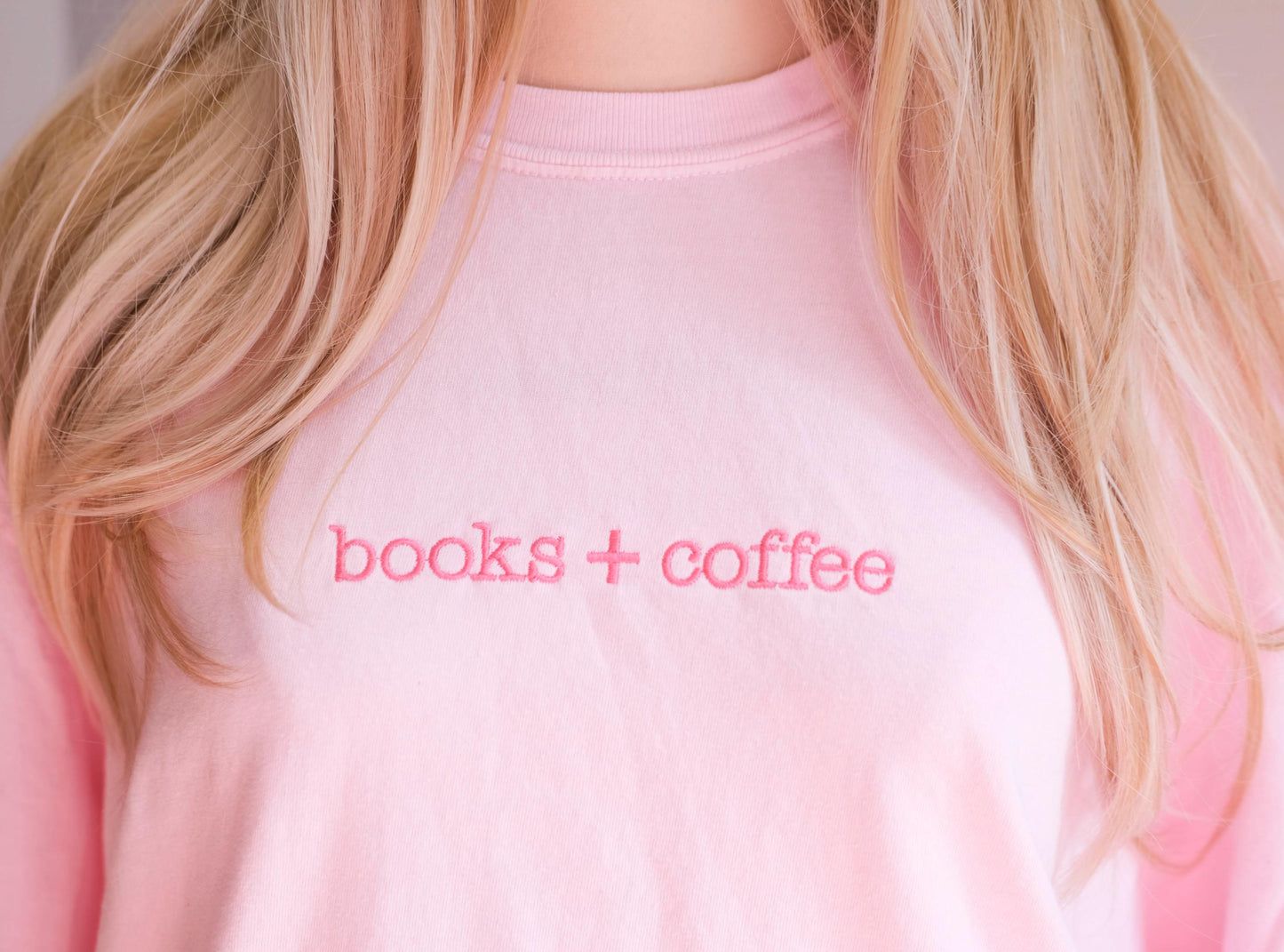 a close up of a person wearing a pink shirt