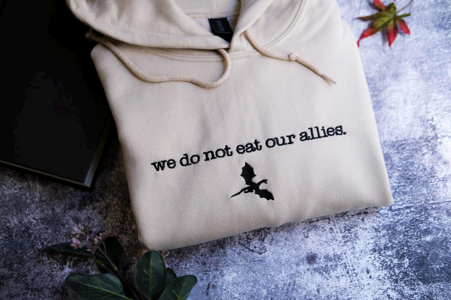 a white sweatshirt with the words we do not eat our alleas on it