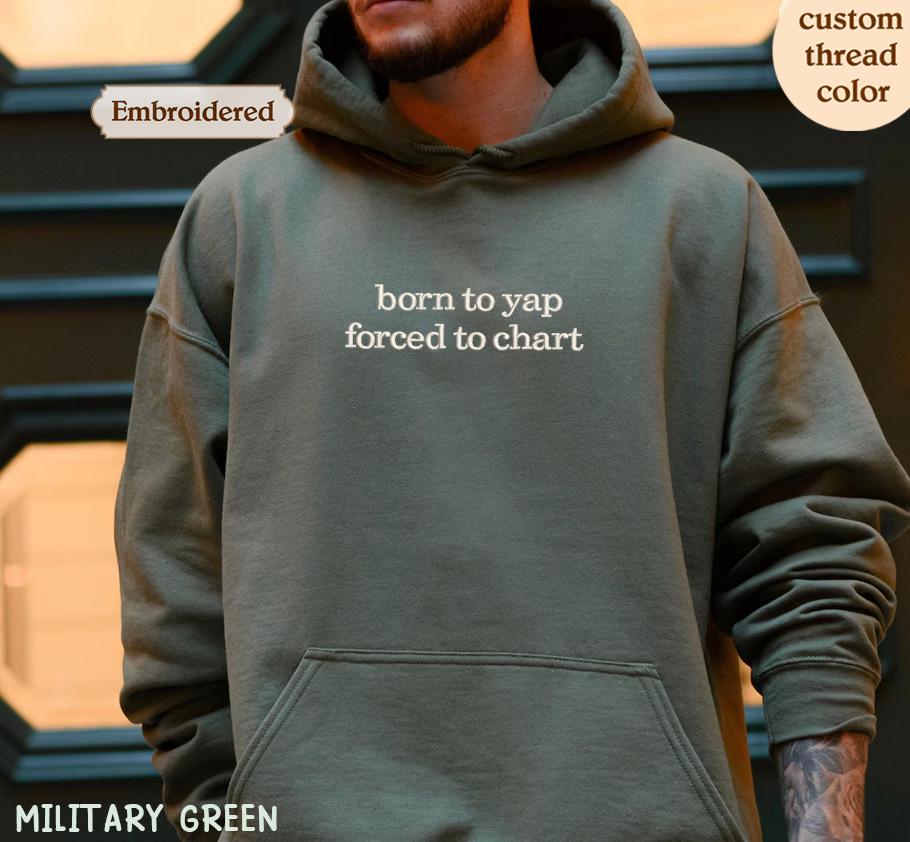 a man wearing a military green hoodie that says born to yap forced to