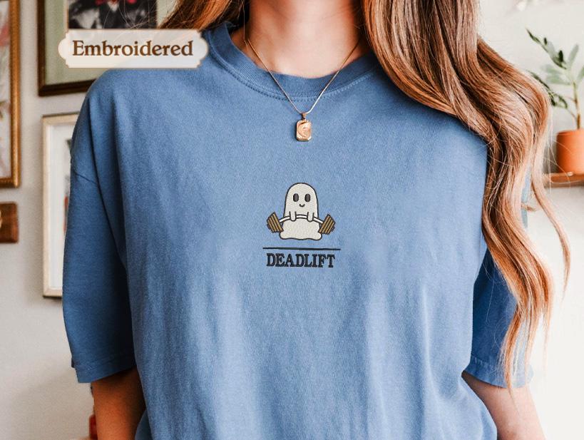 a woman wearing a blue shirt with a ghost on it