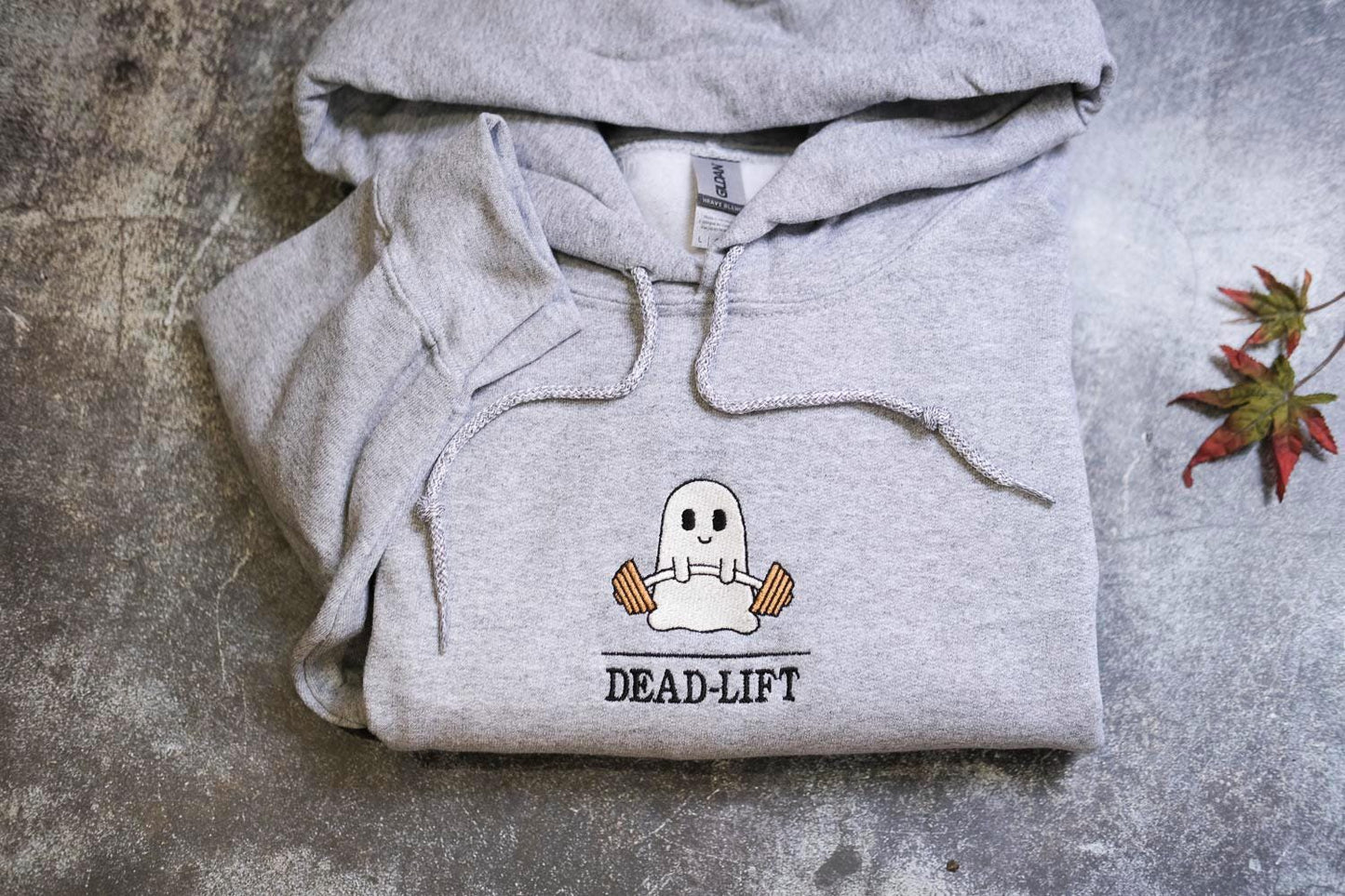 a grey hoodie with a ghost on it