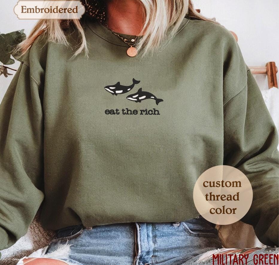 a woman wearing a sweatshirt that says eat the rich