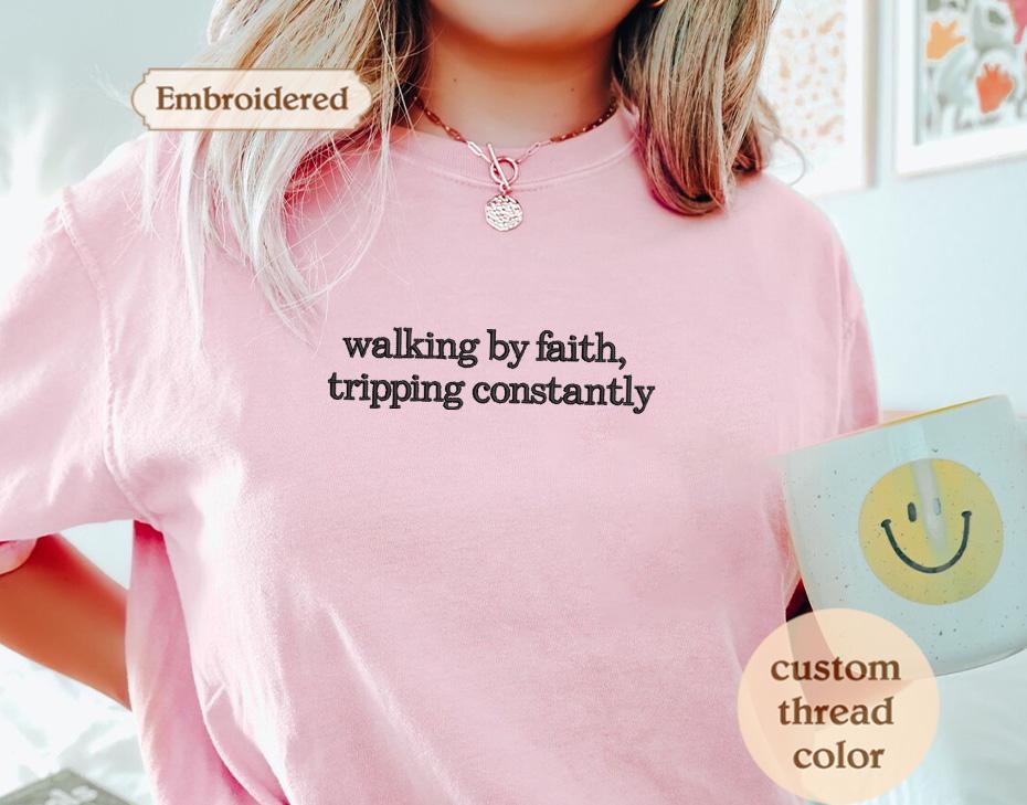 a woman wearing a pink shirt with words on it