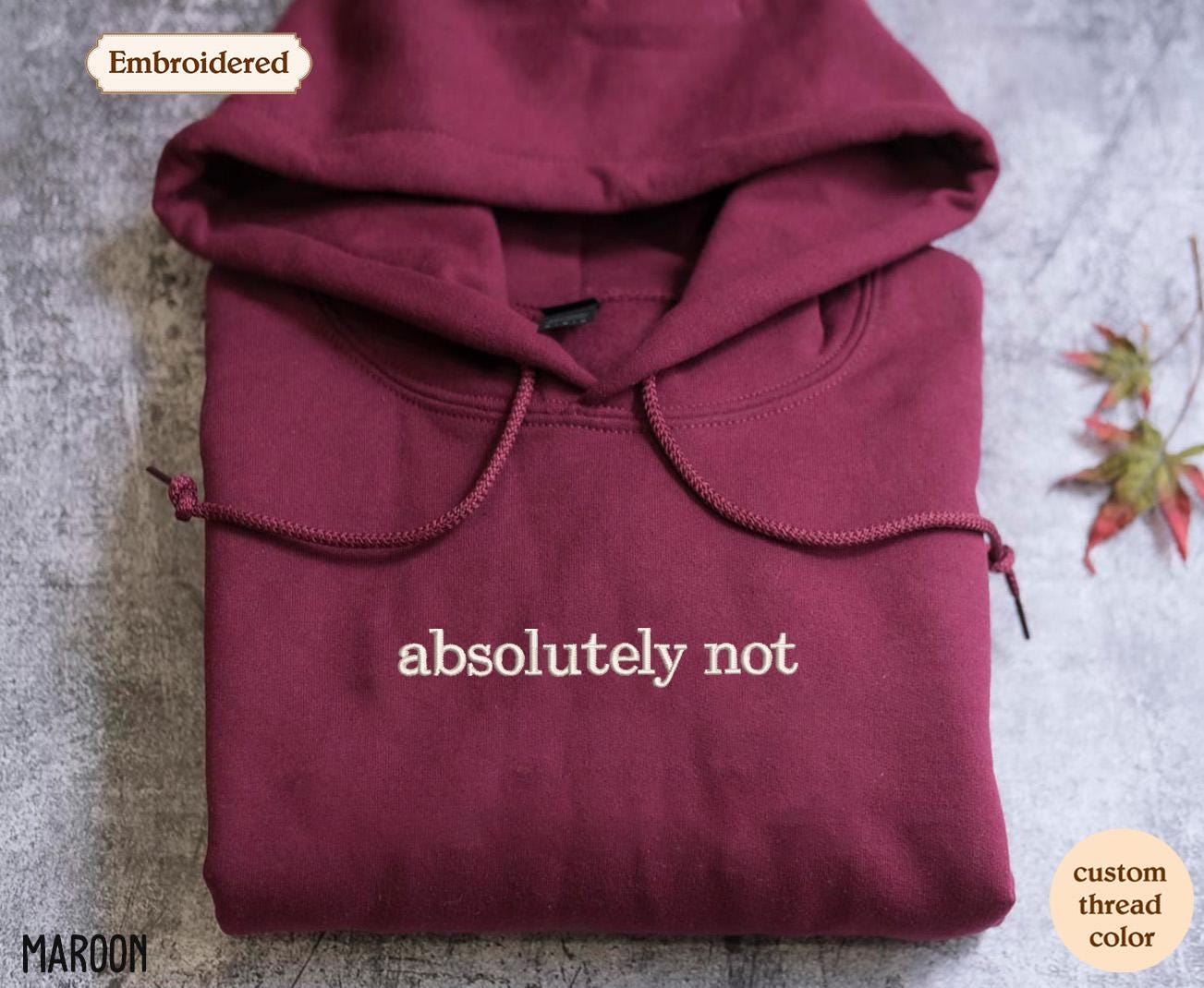 a maroon sweatshirt with the words absolutely not embroidered on it