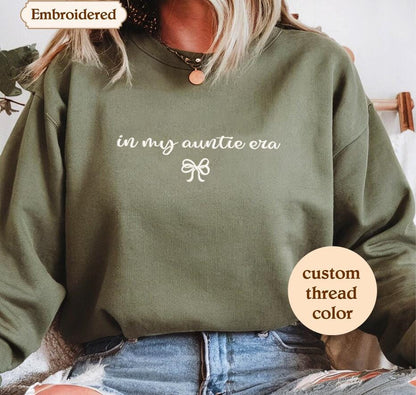 a woman wearing a green sweatshirt that says in my quiltetoa