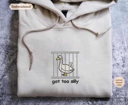 a hooded sweatshirt with a duck in a cage