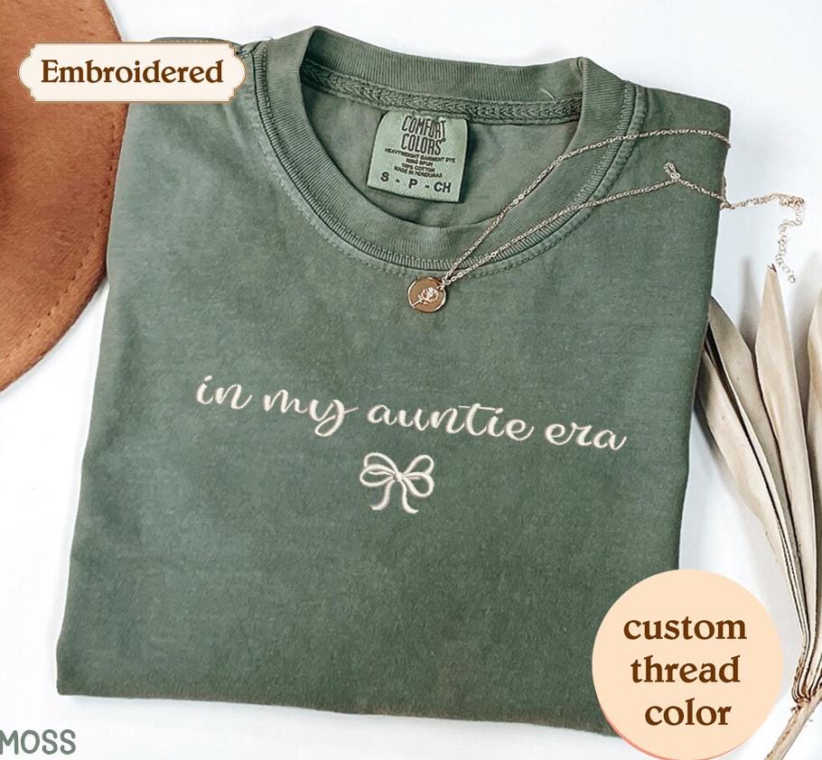 a green t - shirt with the words in my outfit era on it