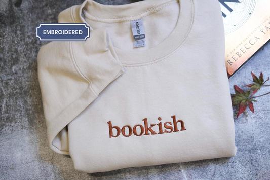 a bookish shirt sitting on a table next to a book