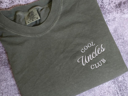 A gray t-shirt with the text "Cool Uncle Club" printed on it.