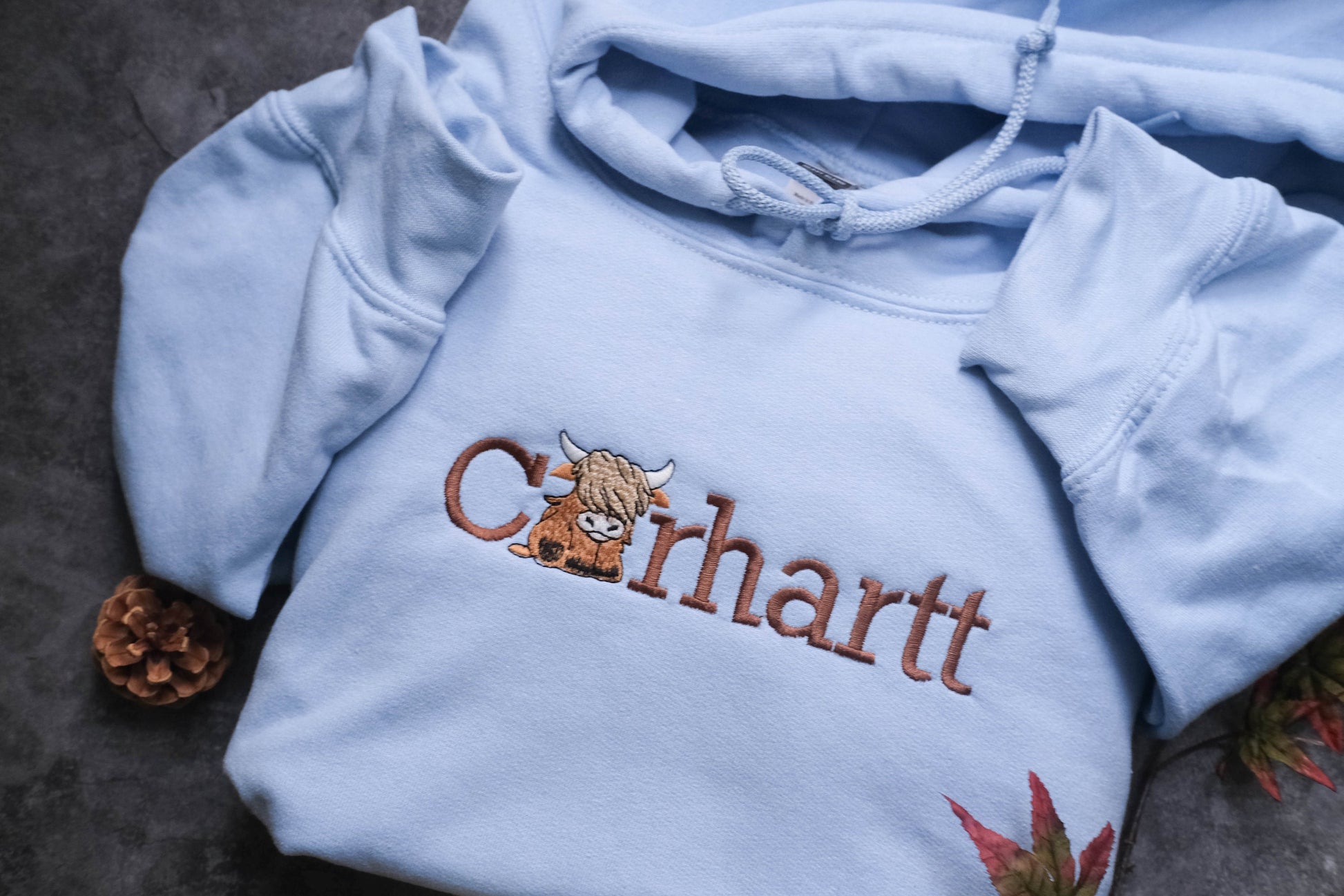 a close up of a blue shirt with a cat on it