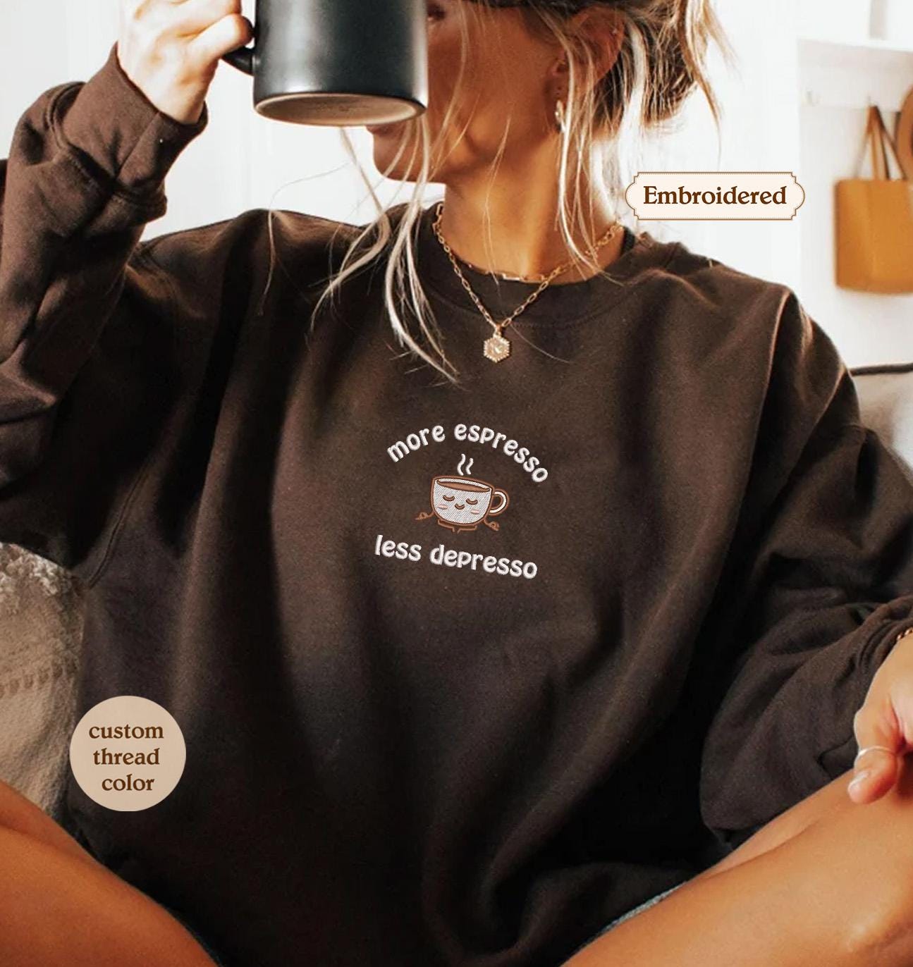 a woman sitting on a couch holding a cup of coffee