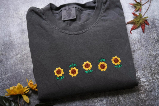 a t - shirt with sunflowers embroidered on it