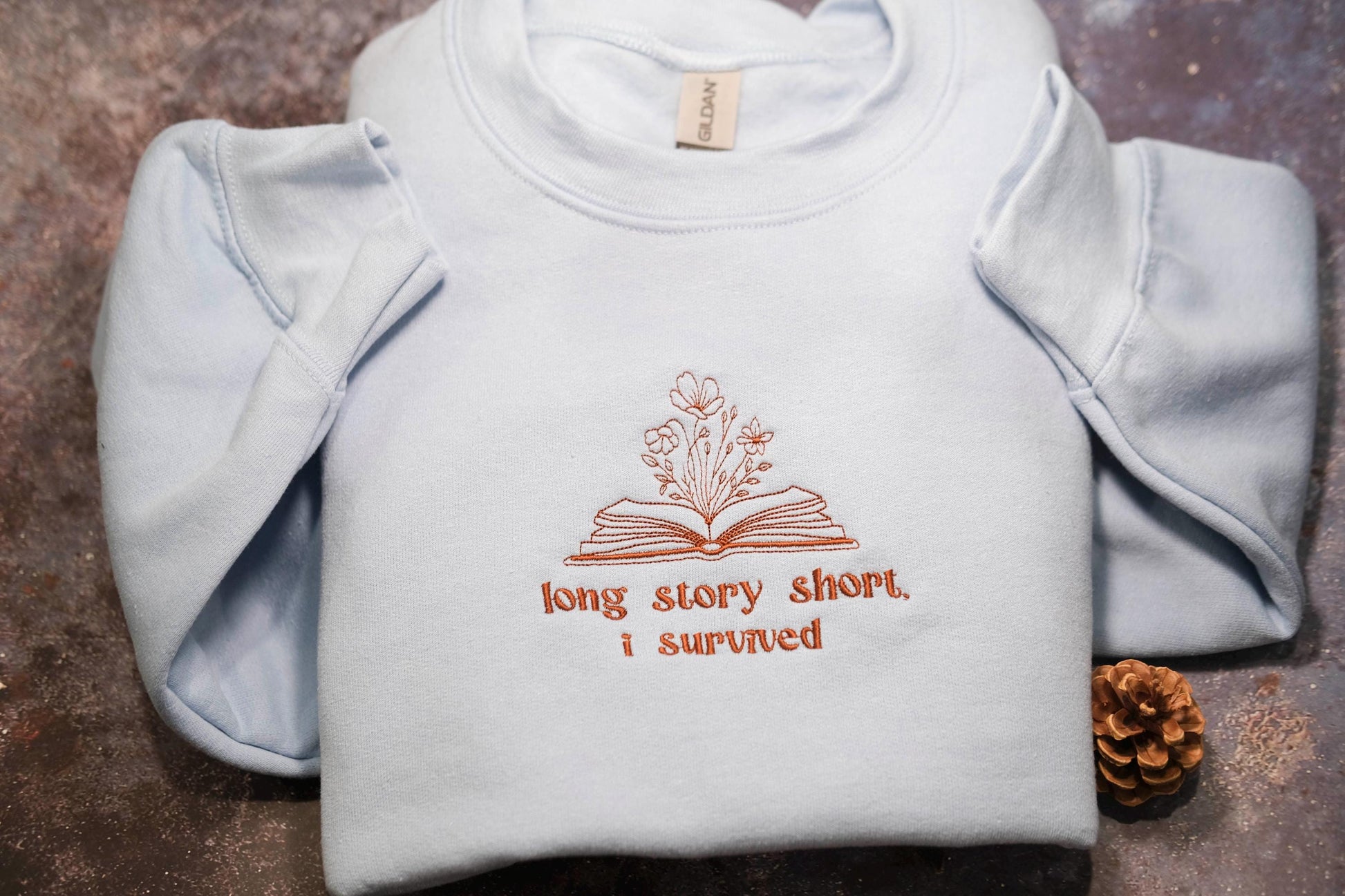 a white shirt with the words long story short i survived written on it