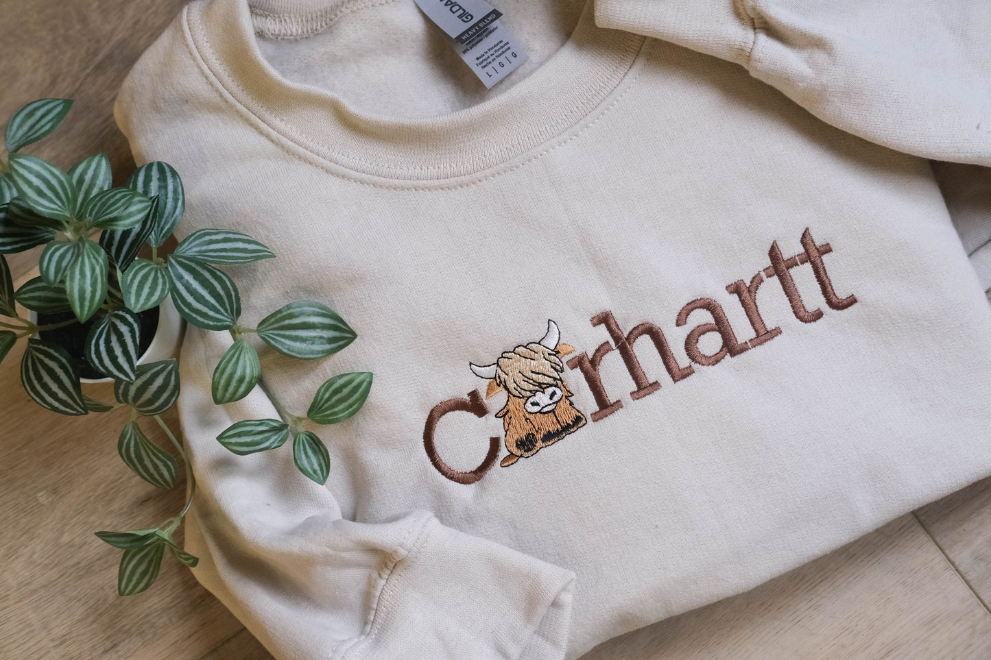 a white shirt with a cow embroidered on it