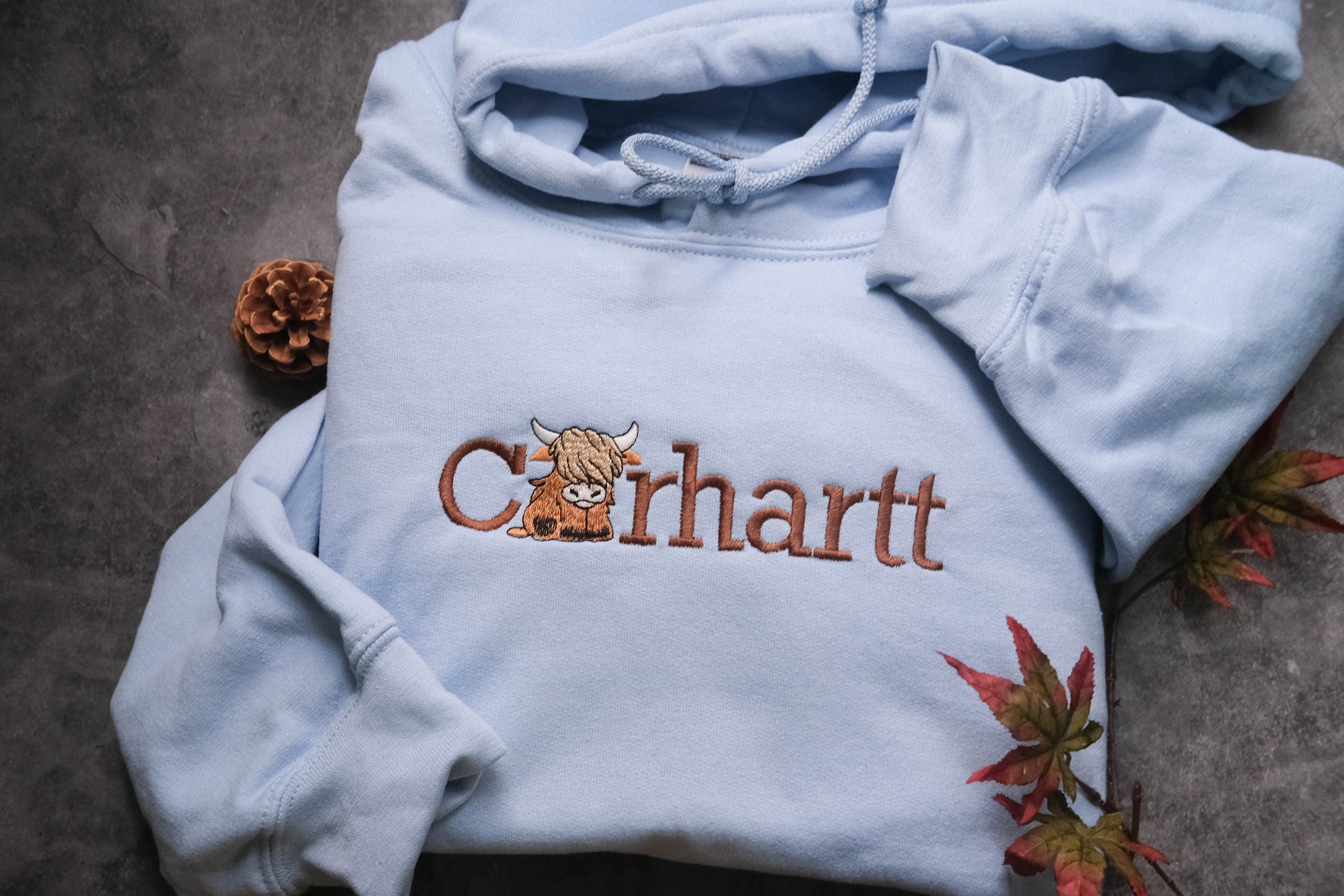 a blue hoodie with a picture of a cow on it