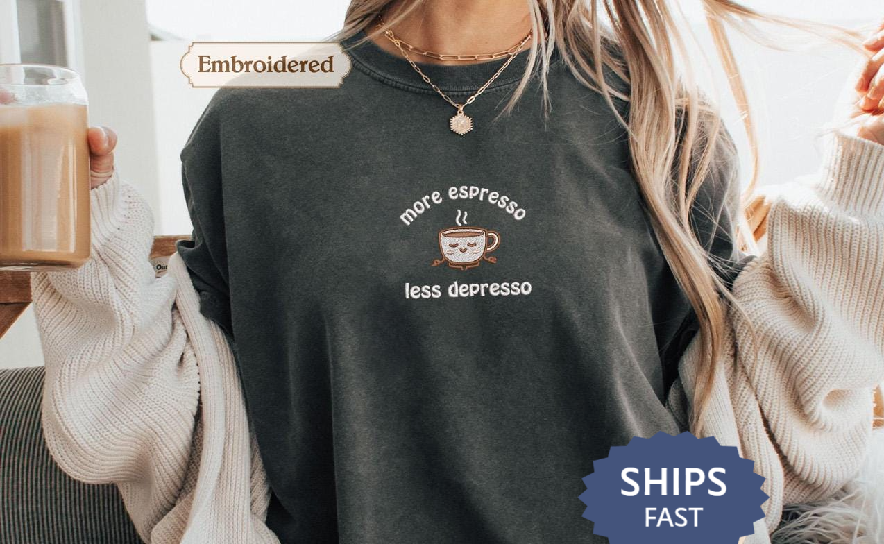 a woman sitting on a couch holding a cup of coffee