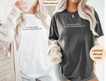 two women wearing matching t - shirts with the words embroidered on them