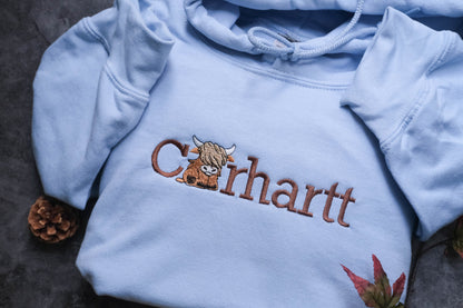 a blue shirt with a picture of a cow on it