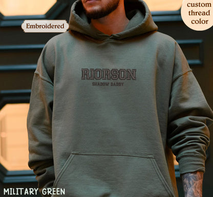 A person wearing a green hoodie with the text "RIORSON SHADOW DADDY" printed on it.