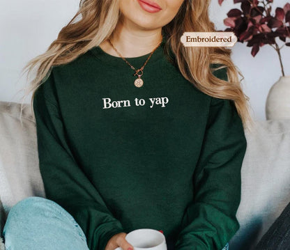a woman sitting on a couch holding a coffee cup