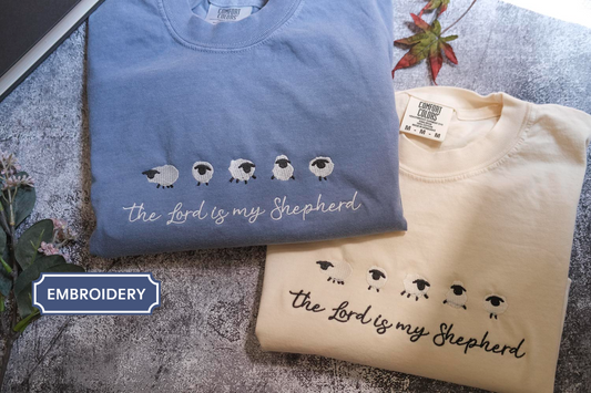two t-shirts with the text "The Lord is my Shepherd" printed on them, along with a small illustration of sheep.