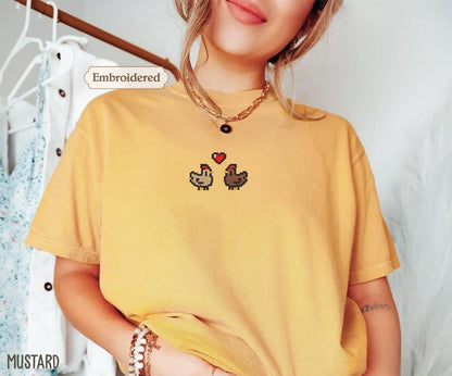 a woman wearing a yellow shirt with two chickens on it