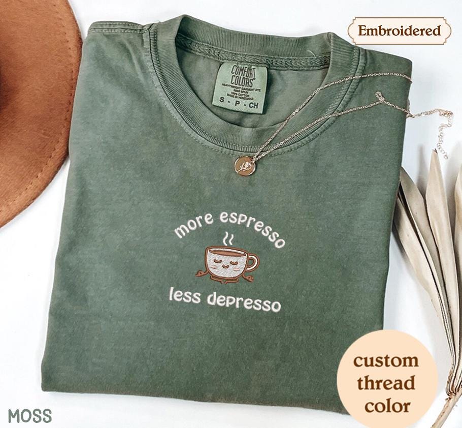 a green t - shirt with a picture of a cup of coffee on it