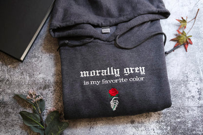 a gray hoodie with the text "morally grey is my favorite color" and a rose graphic, along with a skeleton hand embroidered on the front.