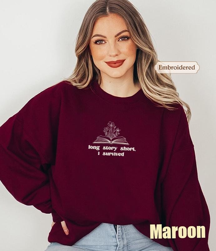 a woman wearing a maroon sweatshirt and jeans