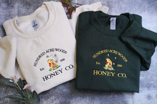 two t-shirts with the same design, laid out on a surface.