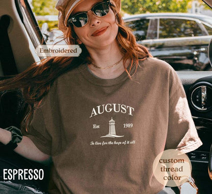 a woman sitting in a car wearing a hat and sunglasses