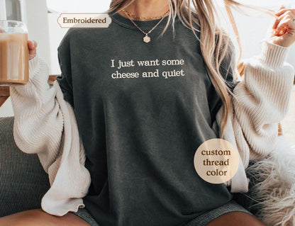a woman sitting on a couch holding a cup of coffee