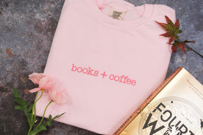 a pink t - shirt that says coffee + cookies next to a book