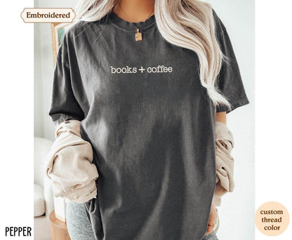 a woman wearing a t - shirt that says books + coffee