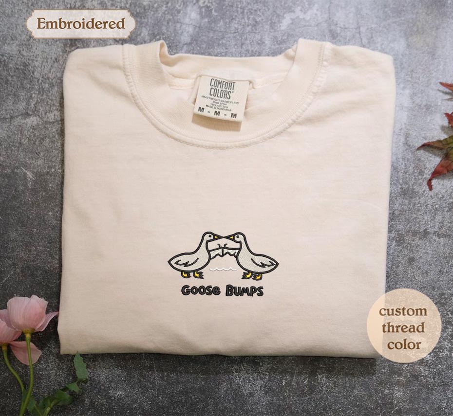 a white t - shirt with a pair of shoes on it