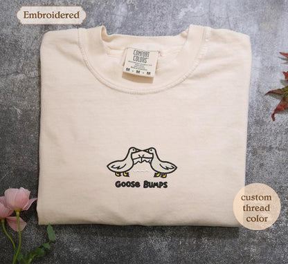 a white t - shirt with a pair of shoes on it