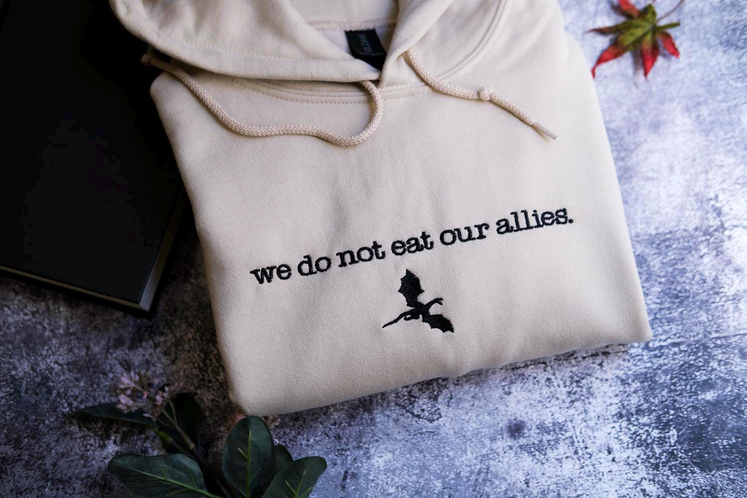 a white sweatshirt with the words we do not eat our alleas on it