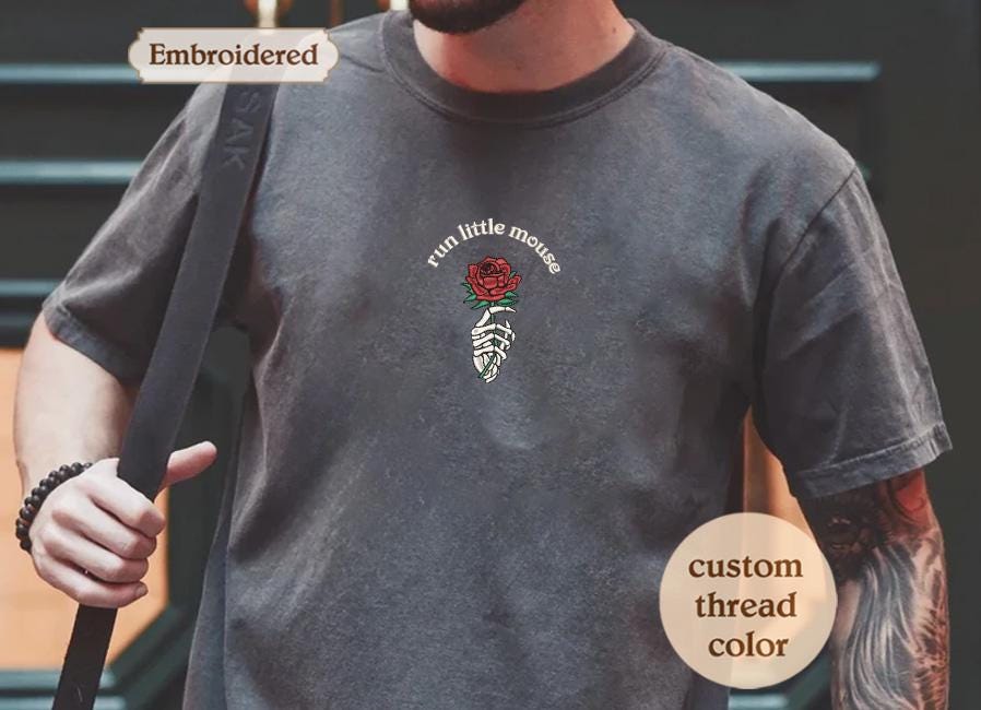 a man wearing a t - shirt with a rose on it