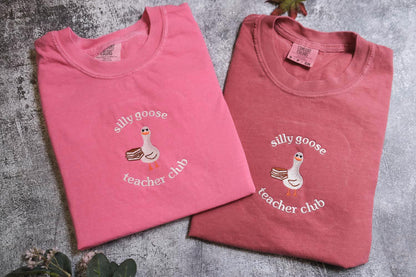 two t - shirts with a duck and a goose on them