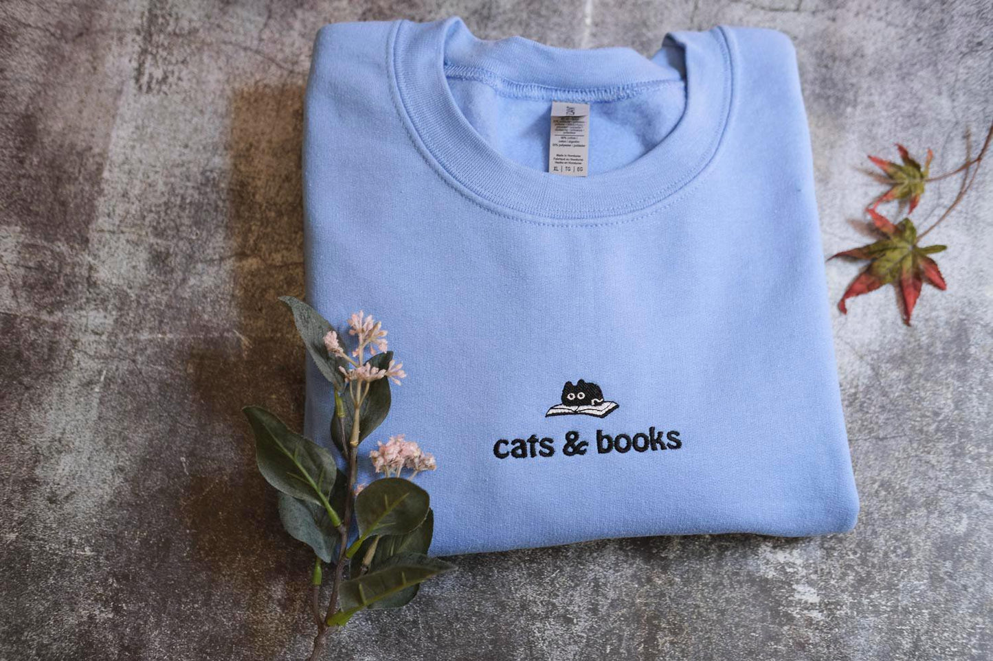 a t - shirt that says cats and books on it