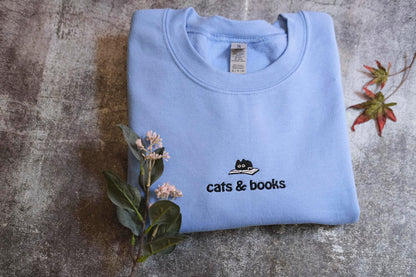 a t - shirt that says cats and books on it