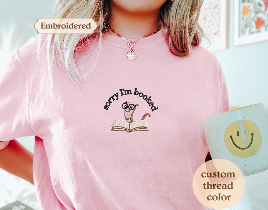 a woman wearing a pink shirt holding a coffee mug