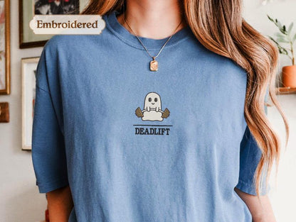 a woman wearing a blue shirt with a ghost on it